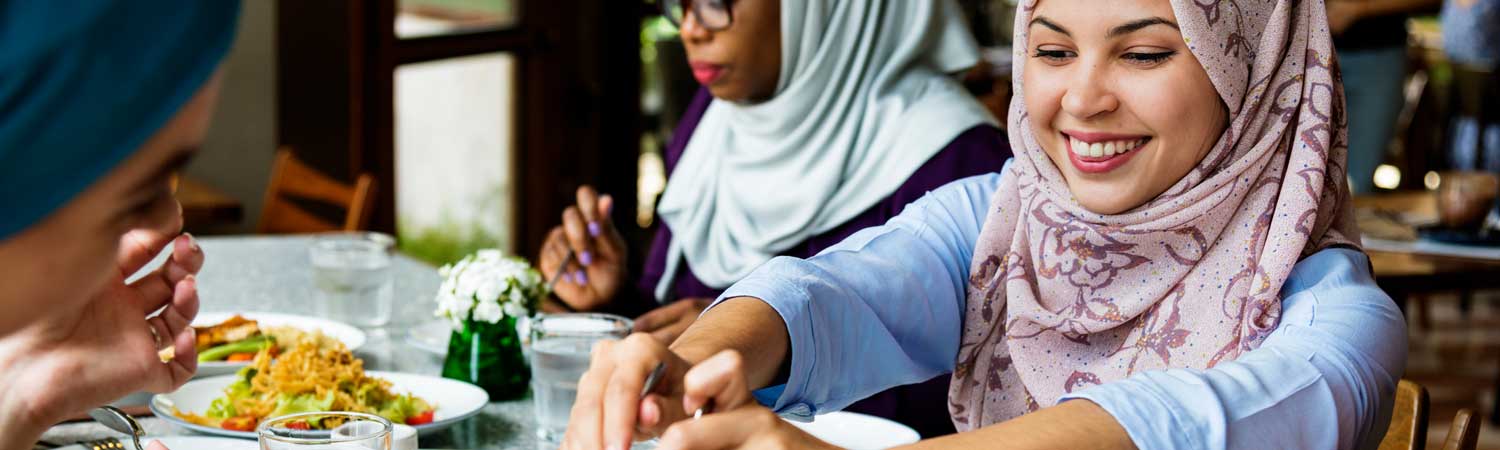 women wearing hijab having dinner